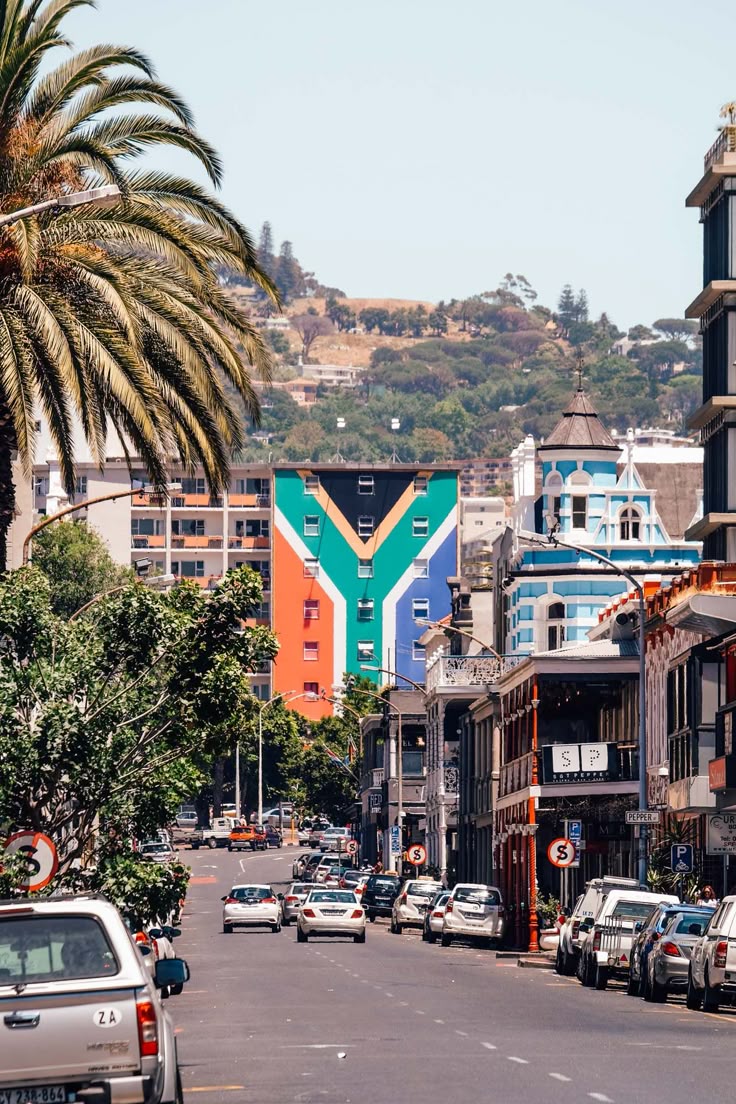A Cape Town street with a building painted in South African flag colors