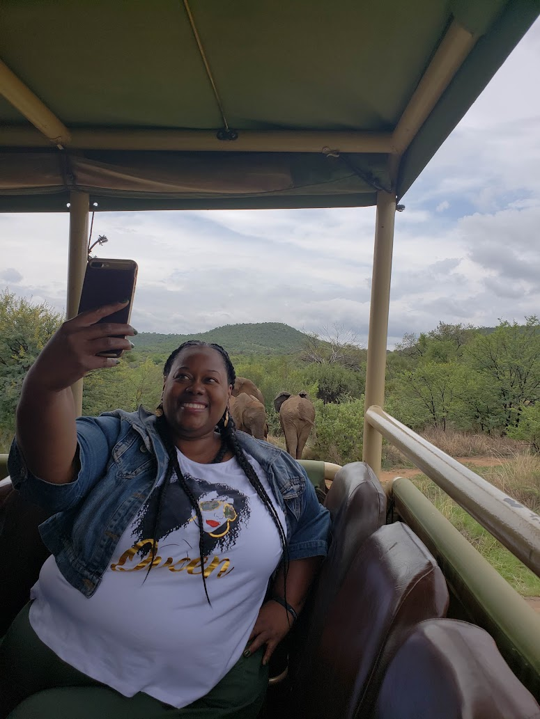 JetLife traveler taking a safari selfie with elephants nearby