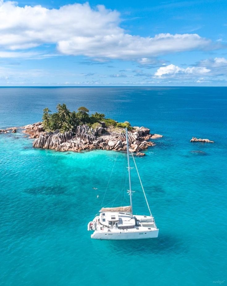 Catamaran sailing in turquoise Seychelles water